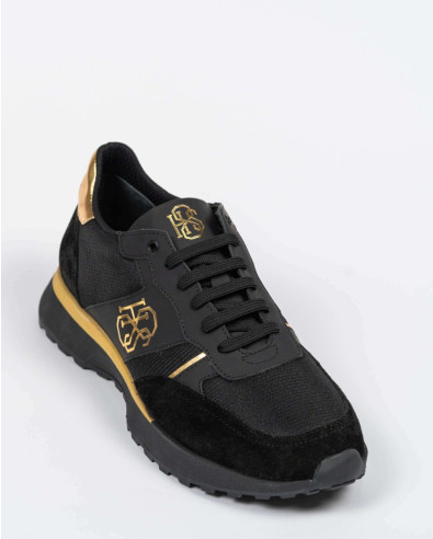 Black sports shoes with gold elements